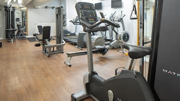 A gym with various exercise equipment, including treadmills and weight machines.
