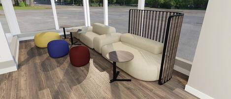 A modern living room with a sectional sofa, round ottomans in yellow, blue, and red, and a small round table.