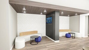 A modern waiting area with a herringbone patterned wall, a digital weather display, and a seating arrangement including a sofa and two round tables with stools.