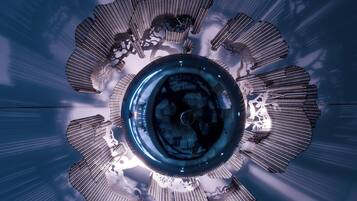 A circular architectural structure with radial elements and a central reflective surface.