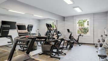 A gym with treadmills, stationary bikes, and weight machines.