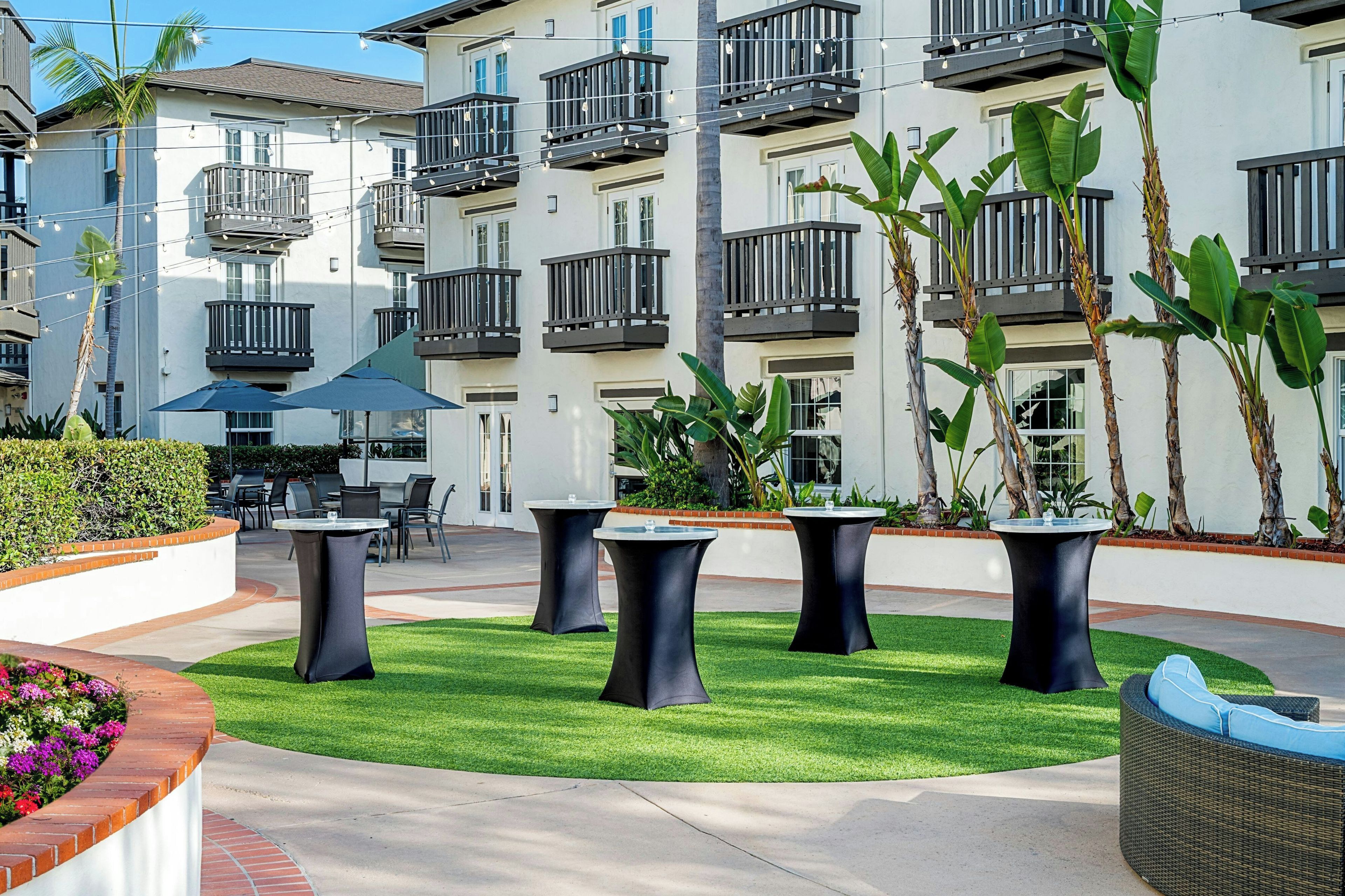A courtyard with outdoor seating and a pool.