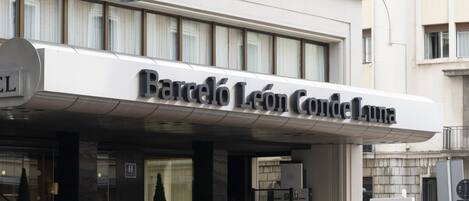 Fachada moderna del hotel Barceló León Conde Luna, con amplias ventanas y una entrada destacada.