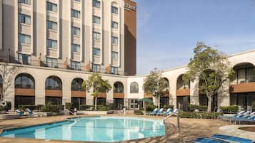 Outdoor pool, open 6:00 AM to 10:00 PM, pool loungers