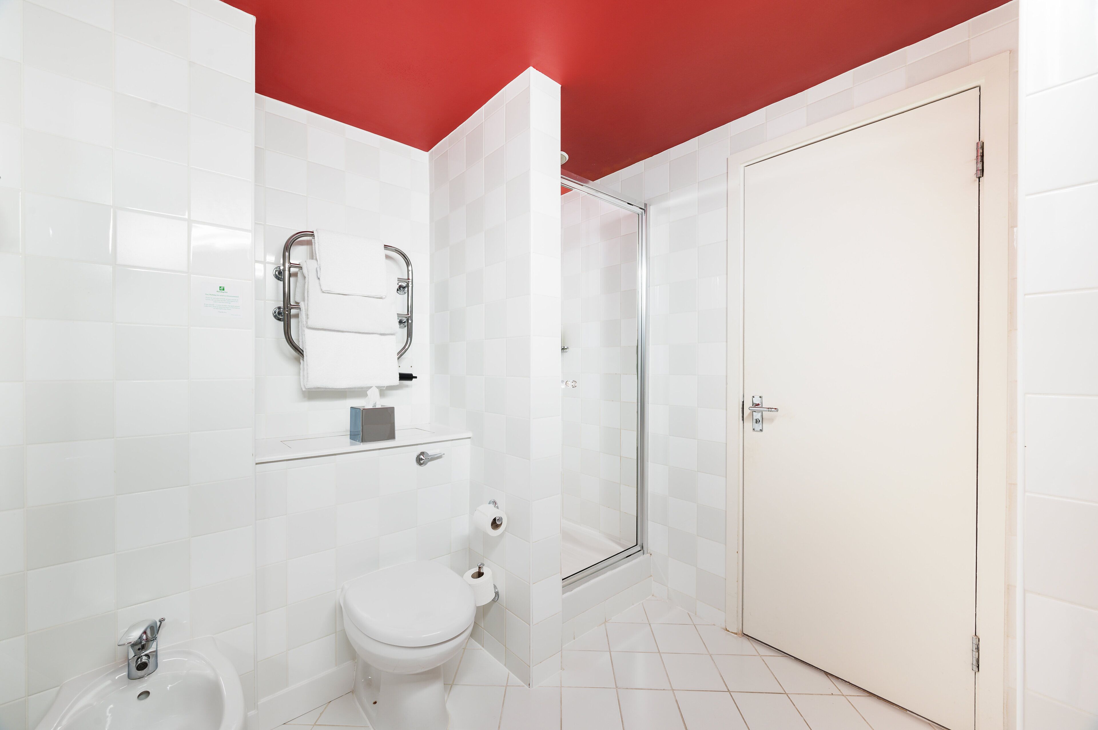 A bathroom with a toilet, bidet, and shower.