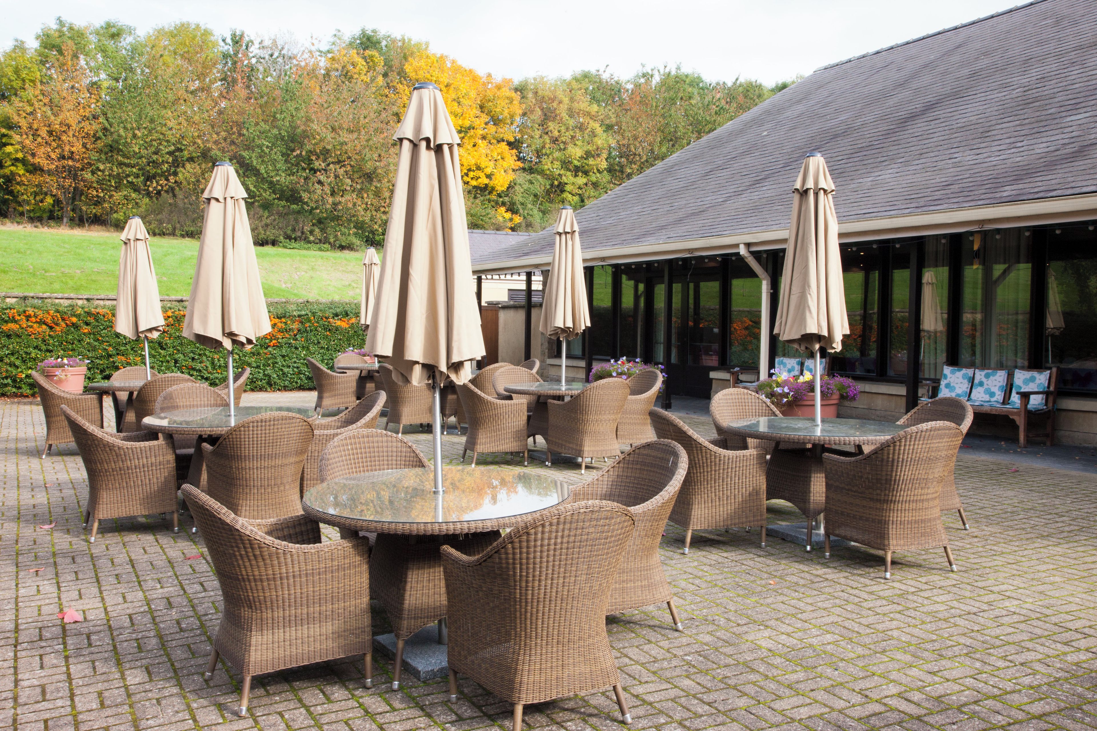 Outdoor patio furniture with tables and chairs, and umbrellas.