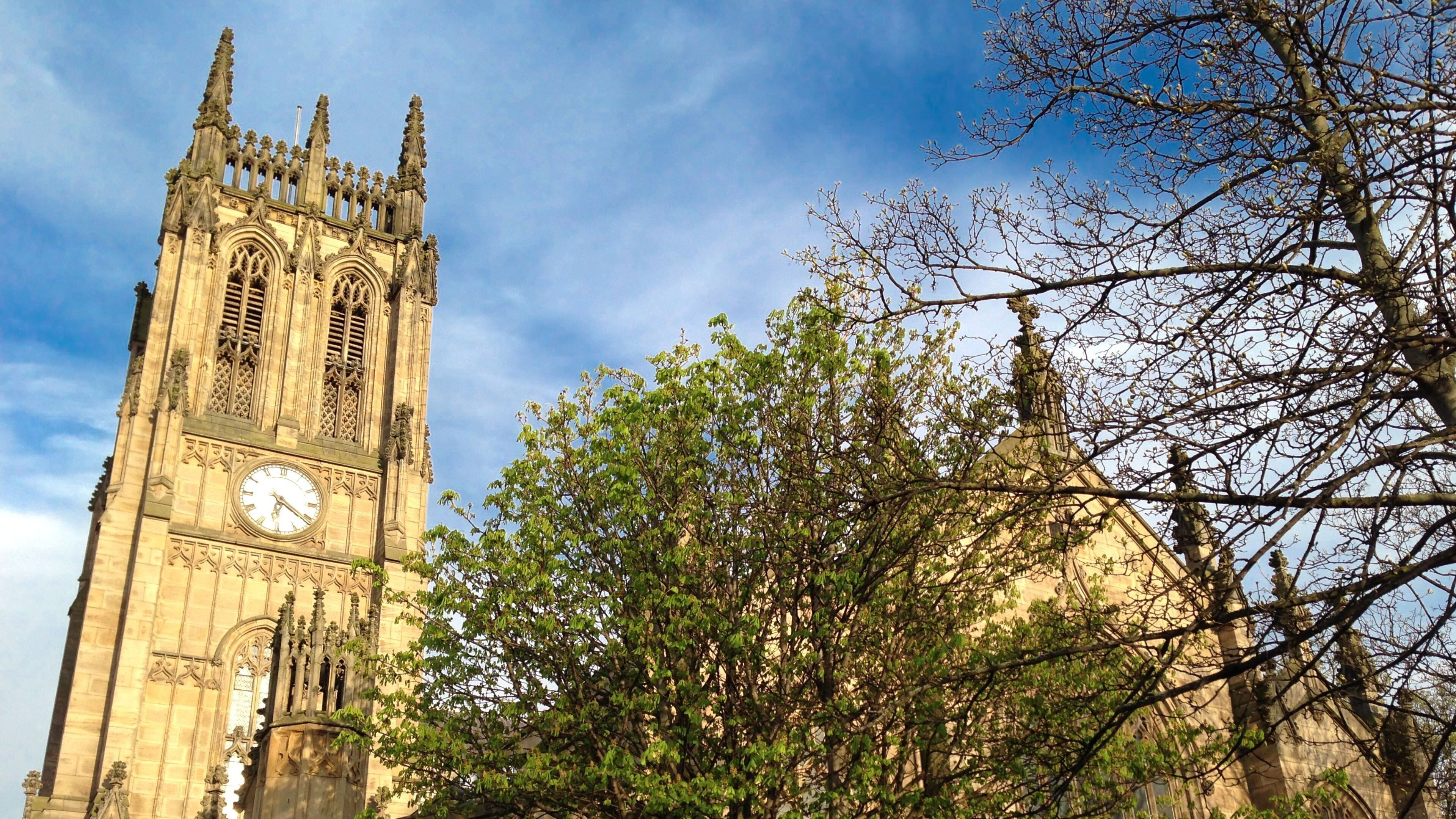 A historic clock tower with intricate architectural details and a large clock face.