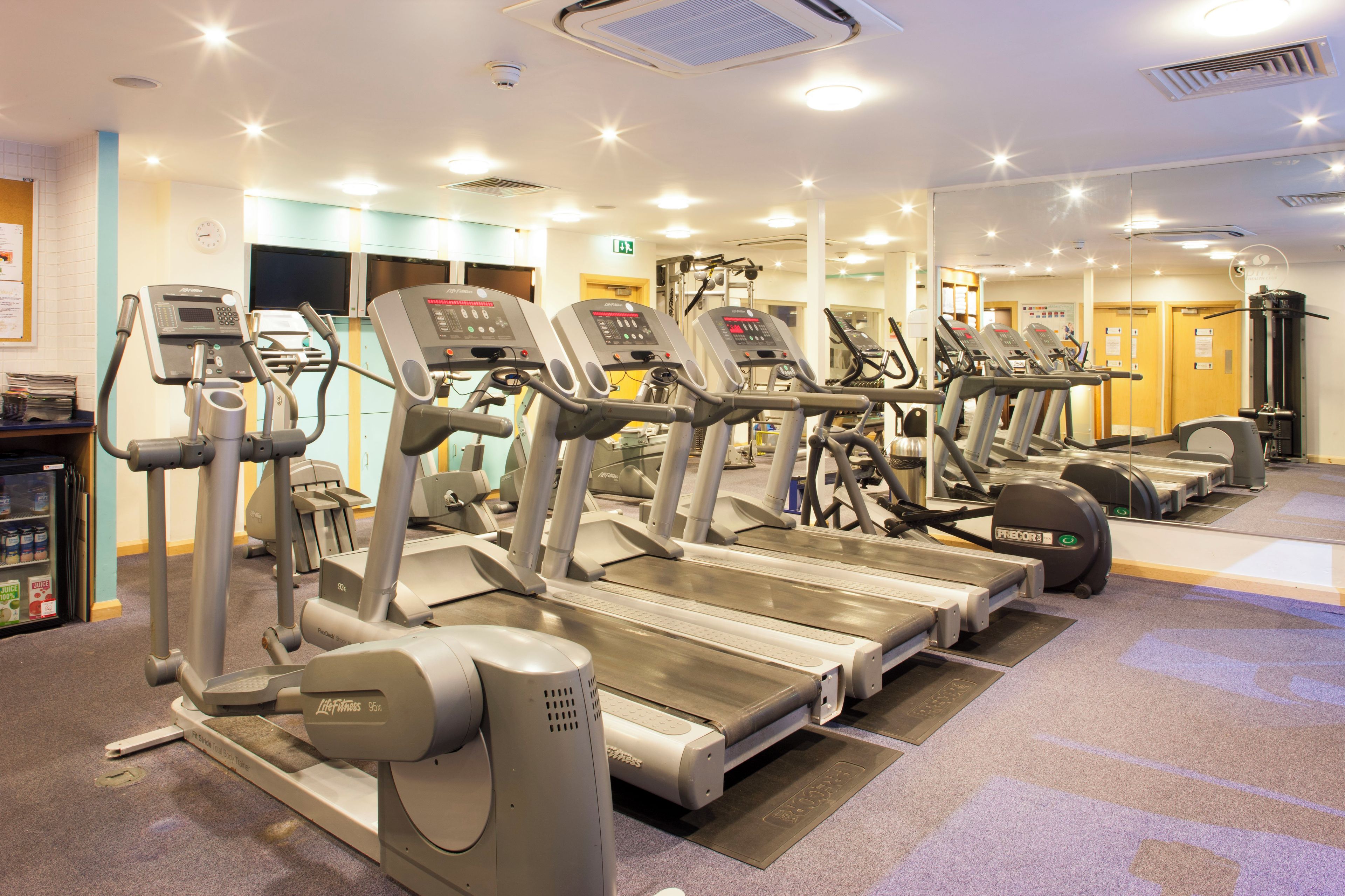 A gym with multiple treadmills and exercise equipment.