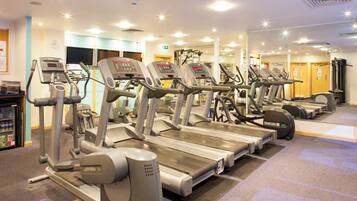 A gym with multiple treadmills and exercise equipment.