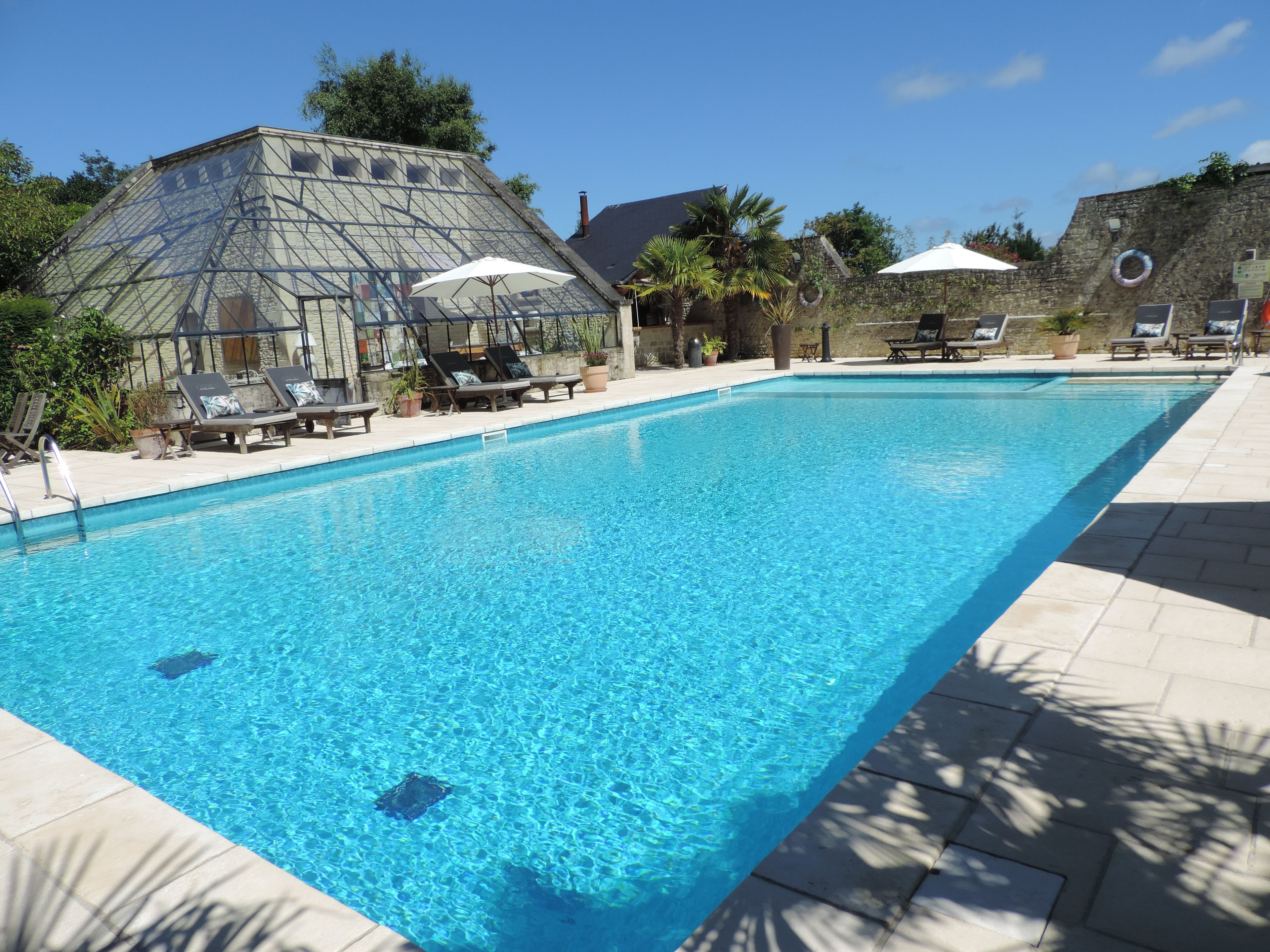 Seasonal outdoor pool, open 8:00 AM to 7:00 PM, pool umbrellas