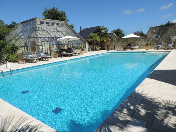 Seasonal outdoor pool, open 8:00 AM to 7:00 PM, pool umbrellas