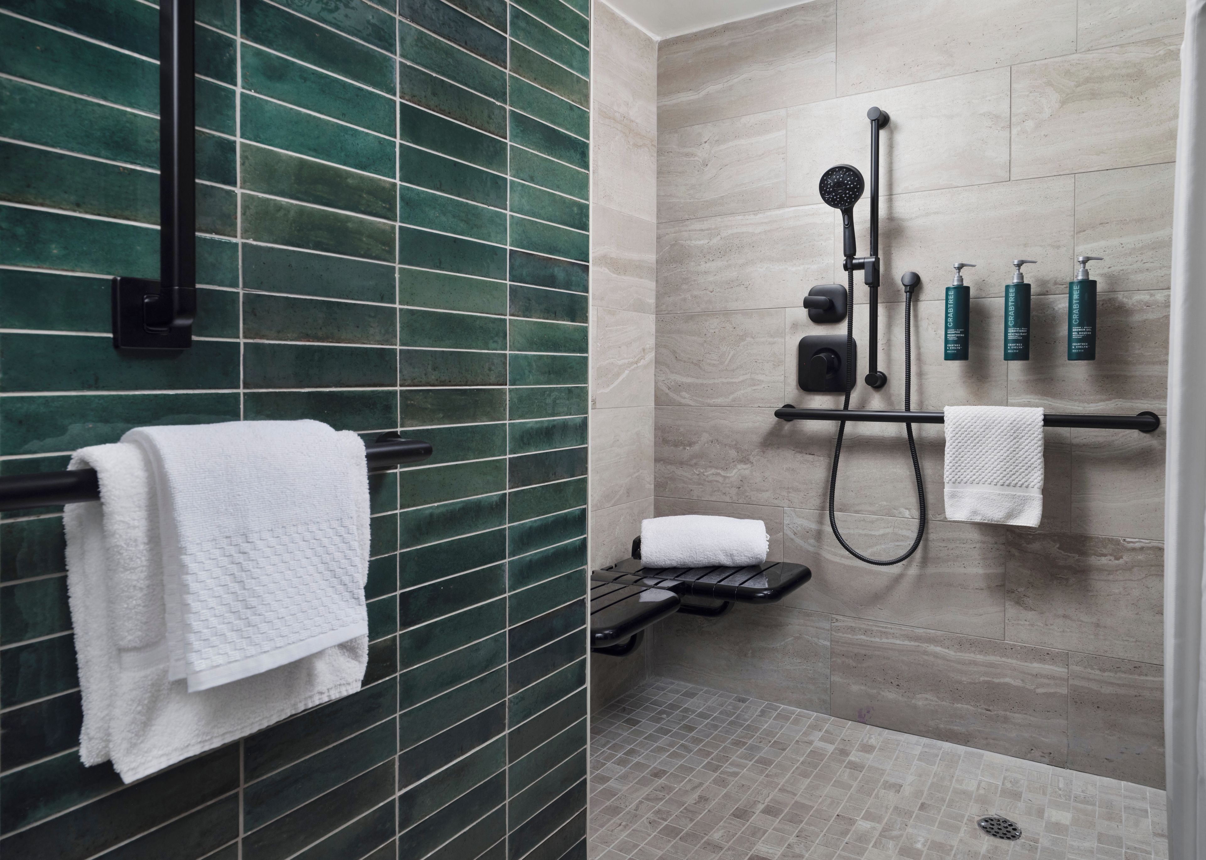A modern bathroom with a shower, a towel rack, and a toilet.