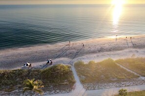 On the beach, white sand, sun-loungers, beach umbrellas