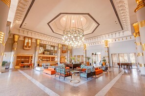 A spacious lobby with a large chandelier, seating areas, and a reception desk. - Continental Hotel Hurghada (Hurghada)