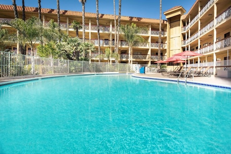 Outdoor pool, sun loungers. Ramada by Wyndham Burbank Airport