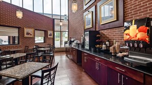 A restaurant interior with brick walls, wooden tables, and a juice bar. - Best Western Plus Reading Inn & Suites (Shillington)