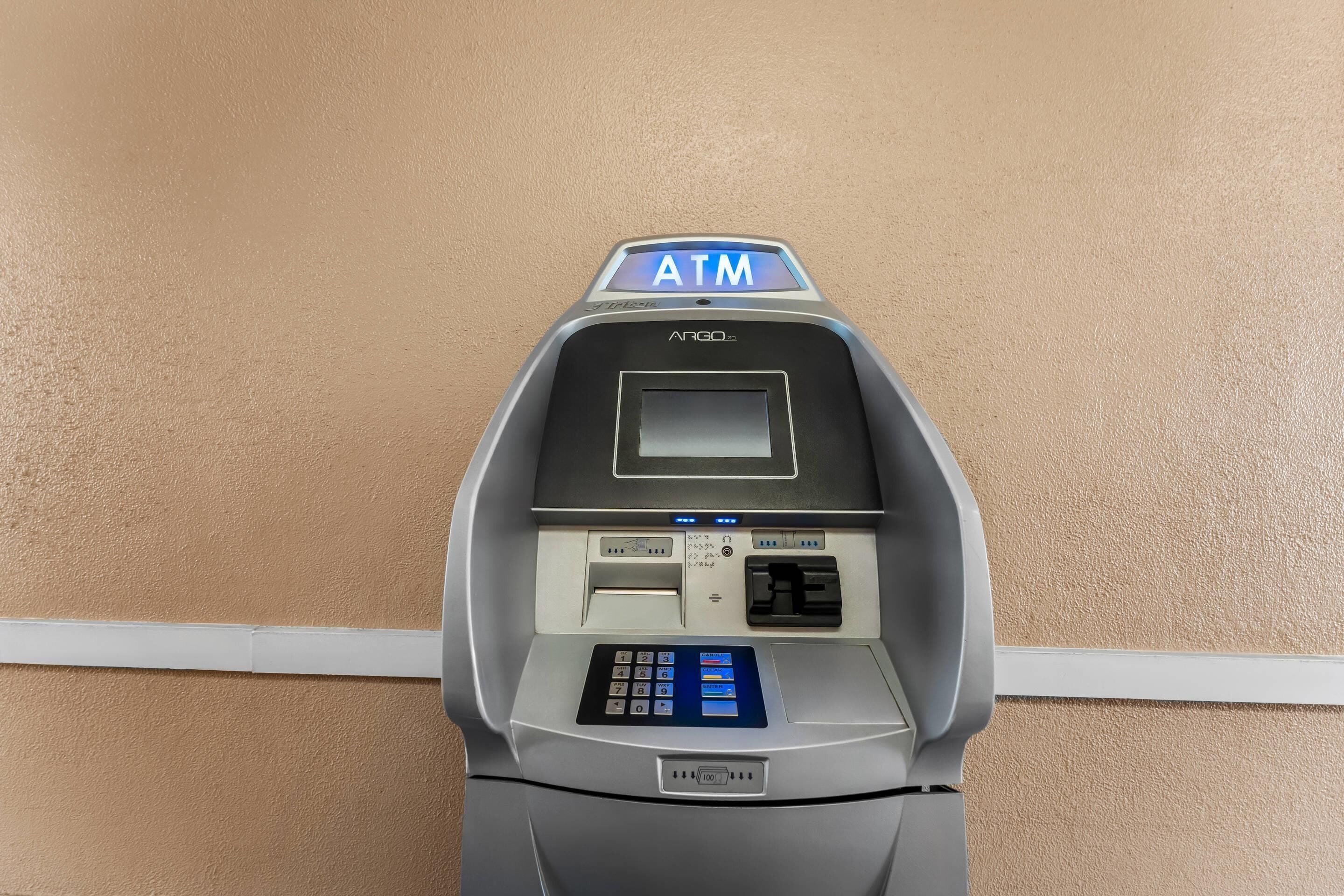 An ATM machine with a keypad, card slot, and a screen.