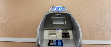 An ATM machine with a keypad, card slot, and a screen.