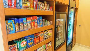 A snack display with various brands like Lay's, Doritos, and Pringles.