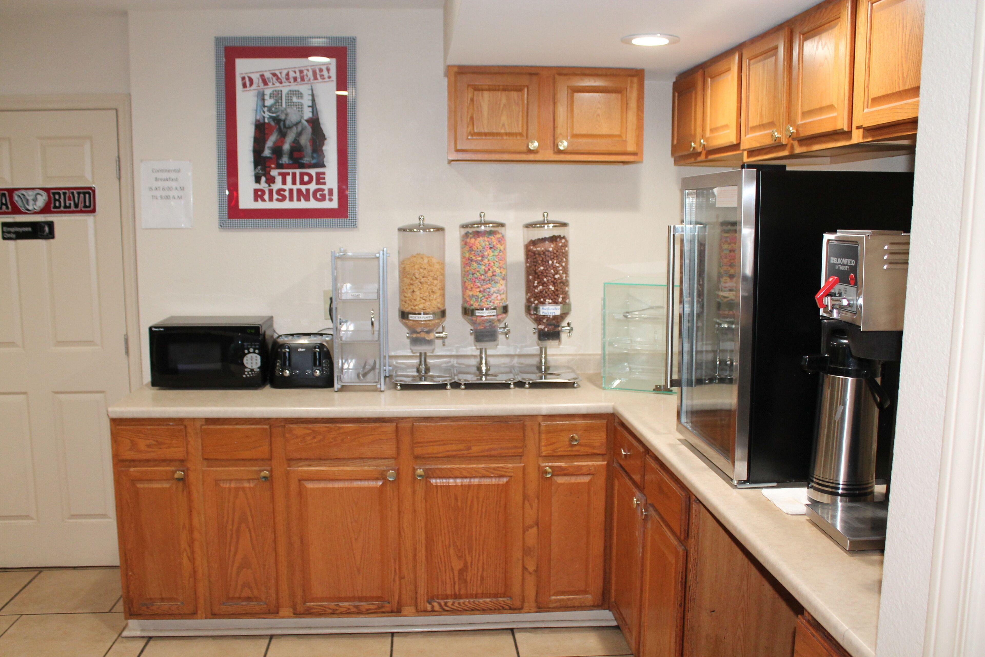 A kitchen with wooden cabinets, a microwave, a toaster, and a coffee maker.