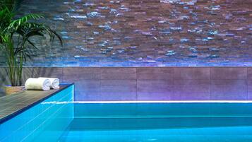 Relax by the serene pool, surrounded by a tranquil atmosphere and lush greenery.