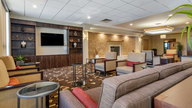 A modern lobby with a large seating area, a flat-screen TV, and a fireplace. - Comfort Inn Glenmont - Albany South (Glenmont)