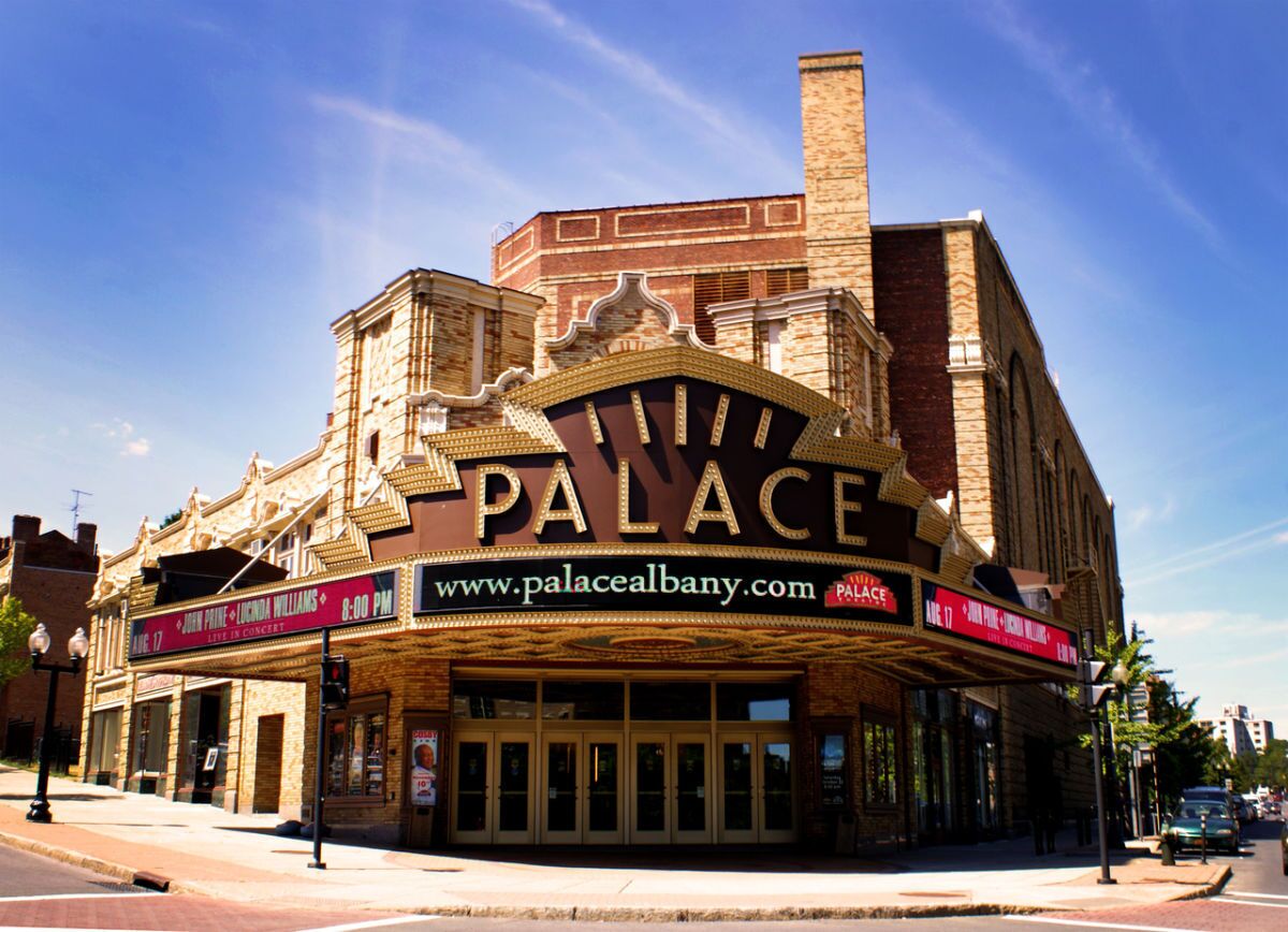 A theater with a marquee reading "PALACE" and a website address "www.palacealbany.com".