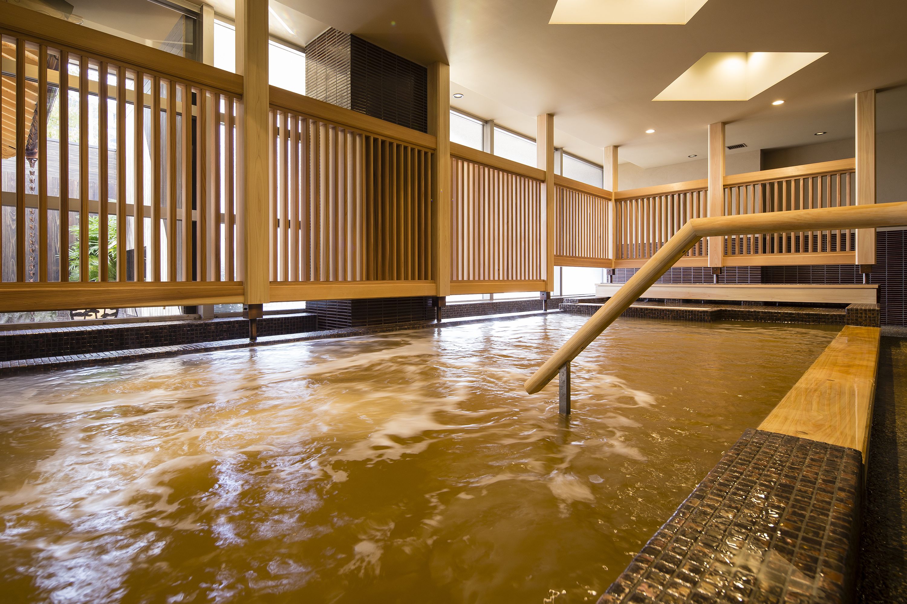 A hot spring area with wooden railings and a tiled floor.