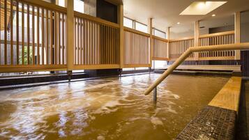 A hot spring area with wooden railings and a tiled floor.