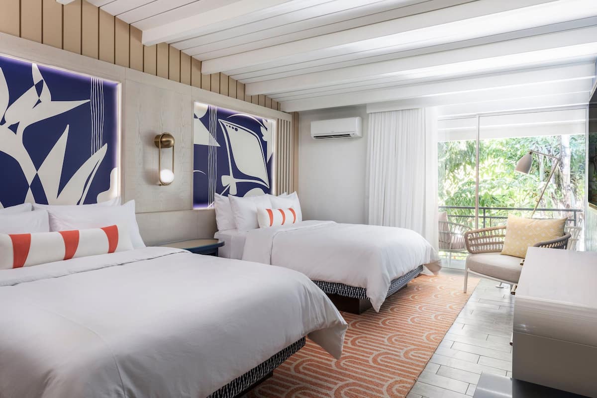 Guest Room, 2 Queens, Balcony | In-room safe, individually decorated, individually furnished