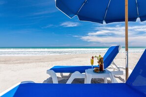 On the beach, sun loungers, beach umbrellas, beach towels