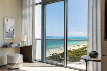 A rooftop terrace with lounge chairs and a view of the ocean. at W South Beach