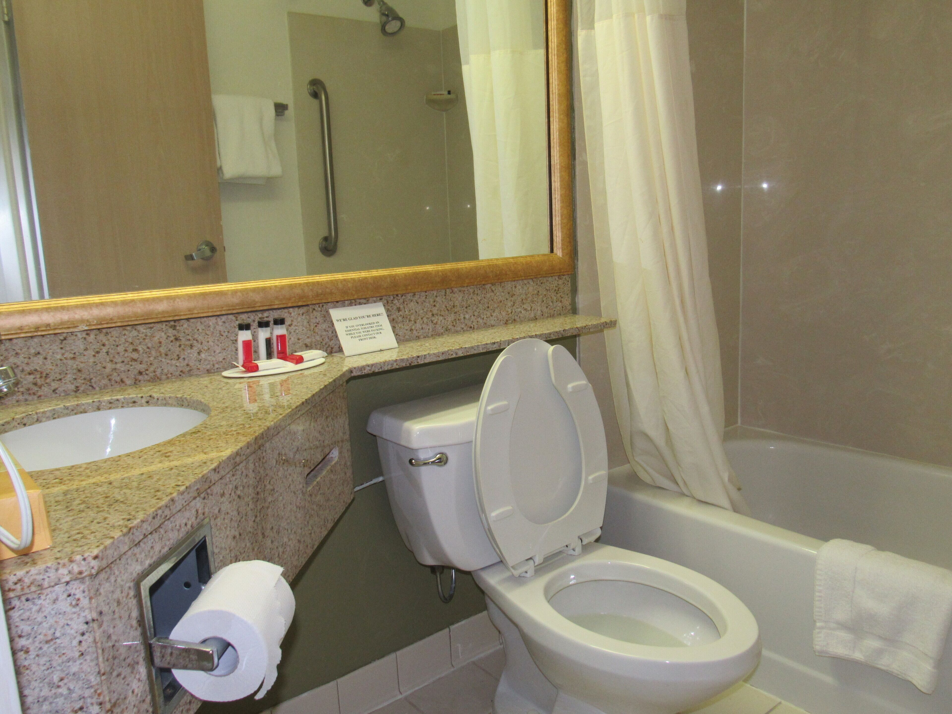 A bathroom with a sink, toilet, and bathtub.