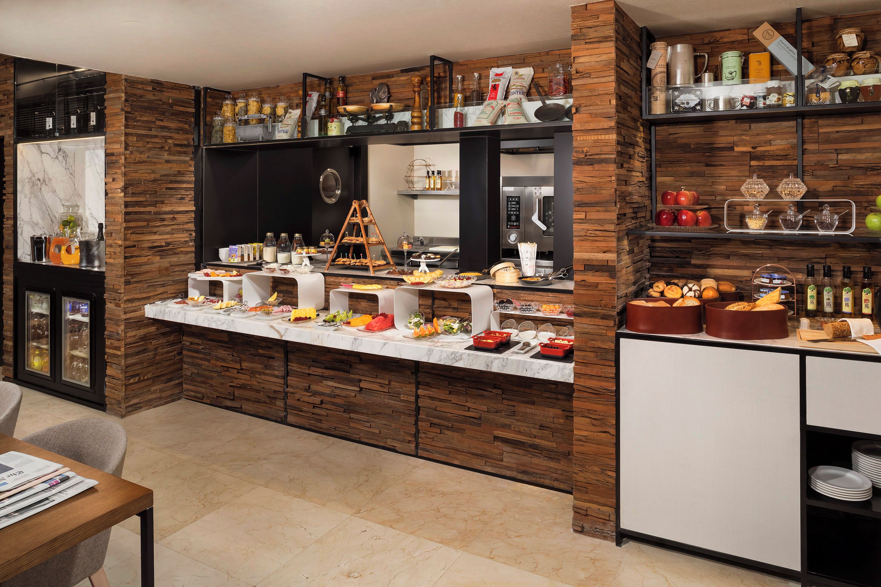 A modern kitchen with a marble countertop, wooden accents, and various kitchen appliances.
