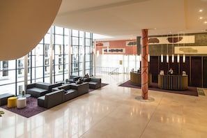Welcome to our lobby, featuring a seating area with sofas and a reception desk.
