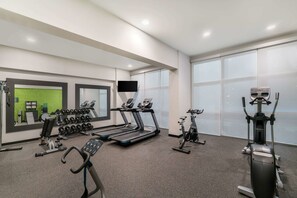 A modern gym with treadmills, stationary bikes, and free weights. - La Quinta Inn & Suites by Wyndham Mobile (Mobile)
