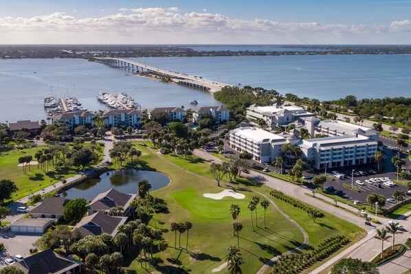An aerial view of a coastal resort with a marina, golf course, and beachfront buildings. - Marriott Hutchinson Island Resort & Beach Villas, Golf & Marina (Stuart)