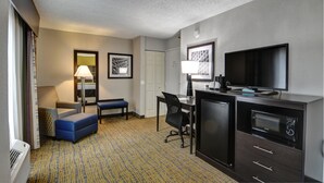 A compact hotel room with a kitchenette, a flat-screen TV, a desk, a chair, and a bed. - Best Western Plus Hanes Mall Hotel (Winston-Salem)
