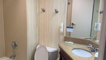 A bathroom with a shower, toilet, and sink.
