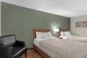 A hotel room with two beds, a chair, a nightstand, and a wall map. - Econo Lodge Longmont East (Longmont)