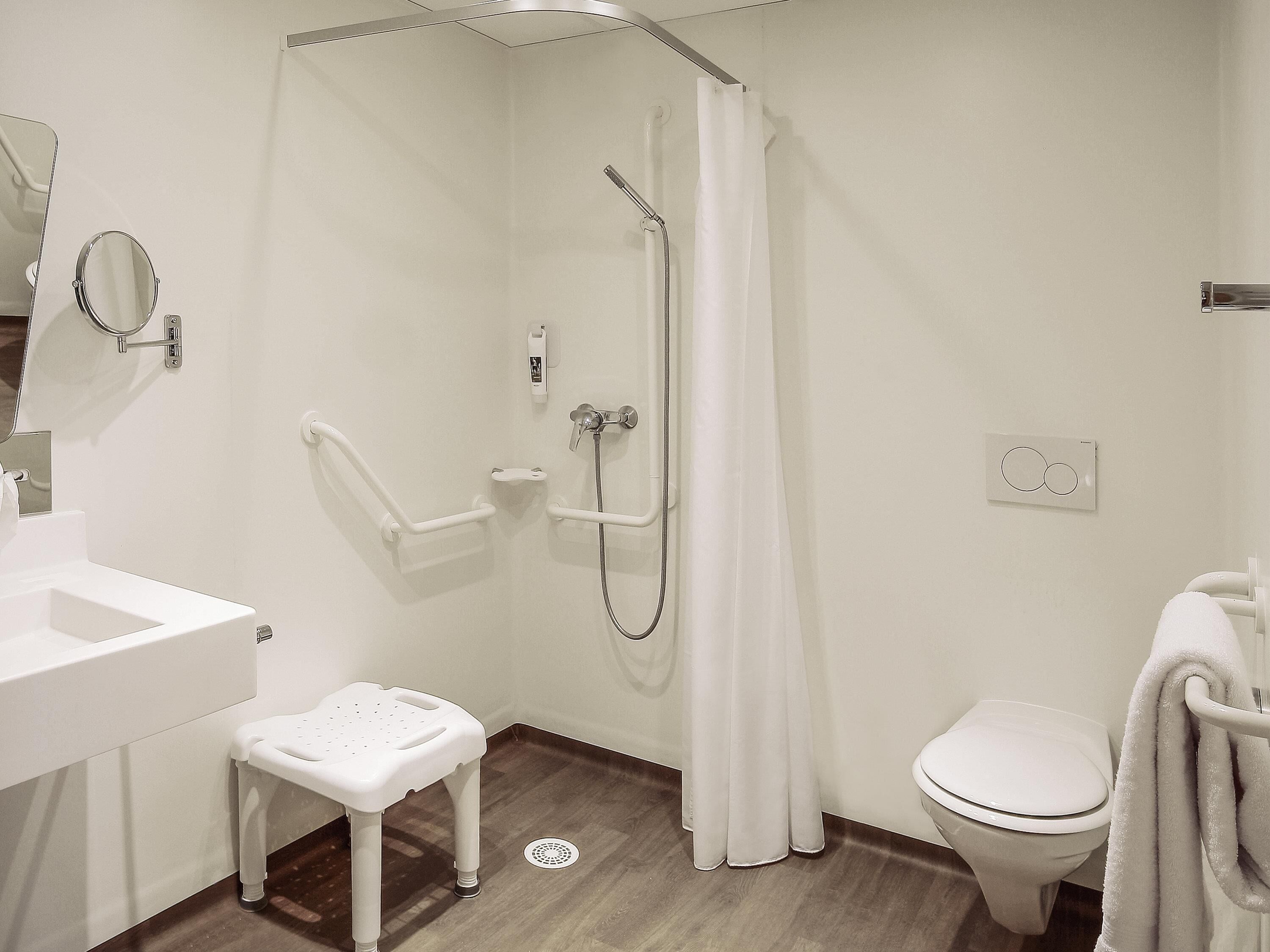 Un baño moderno con ducha, inodoro y lavamanos.