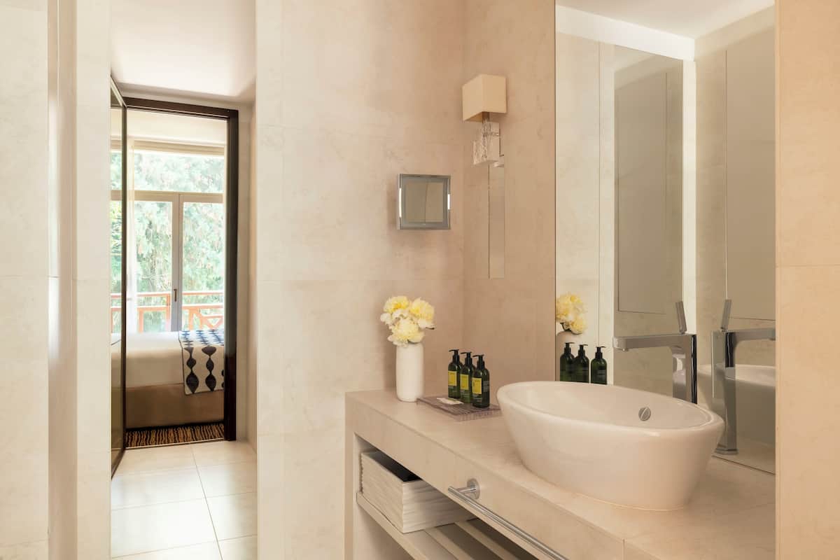 junior suite (south-facing) | bathroom | combined shower/bathtub, designer toiletries, hair dryer, bathrobes