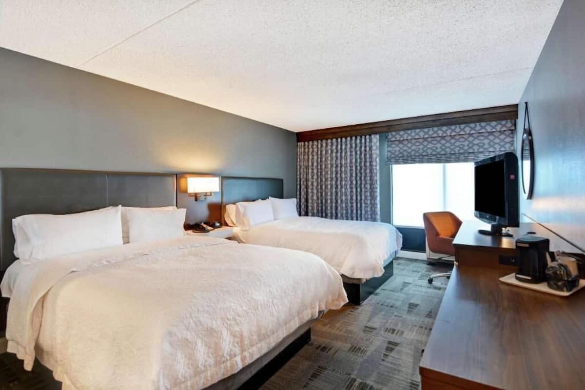 Hypo-allergenic bedding, desk, laptop workspace, blackout drapes