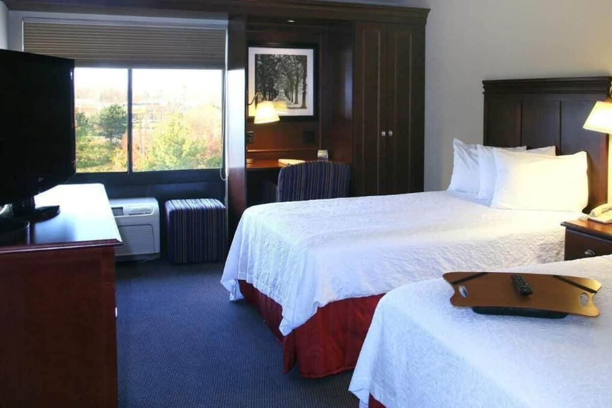 Hypo-allergenic bedding, desk, laptop workspace, blackout drapes