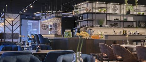 A modern dining area with a bar, seating, and decorative elements.