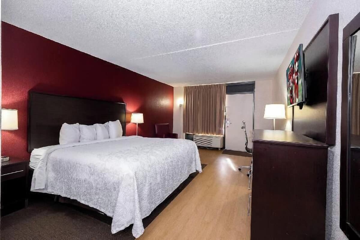 Desk, laptop workspace, blackout drapes, iron/ironing board