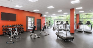 A gym with exercise equipment, a wall of dumbbells, and large windows. - DoubleTree by Hilton Madison Downtown (Madison)