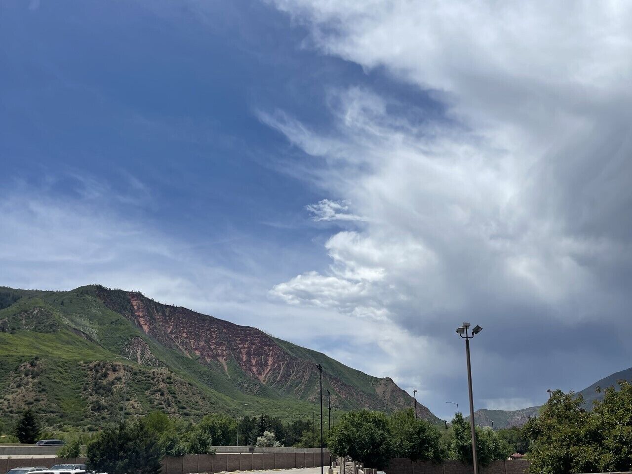A mountainous landscape with a clear sky and a streetlight.
