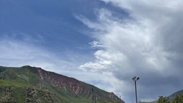 A mountainous landscape with a clear sky and a streetlight.