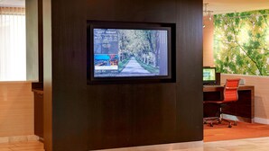 A modern reception area with a digital display showing today's events and weather. - Courtyard by Marriott Lexington North (Lexington)